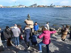 Turistas visitando a Pequena Sereia
